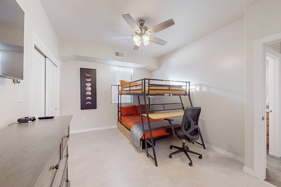 Stay & play in this versatile room featuring dual full size bunk beds with a workspace, ample storage, and a Roku Smart TV with the full main bathroom adjacent- perfect for kids or teens during your extended family stay.