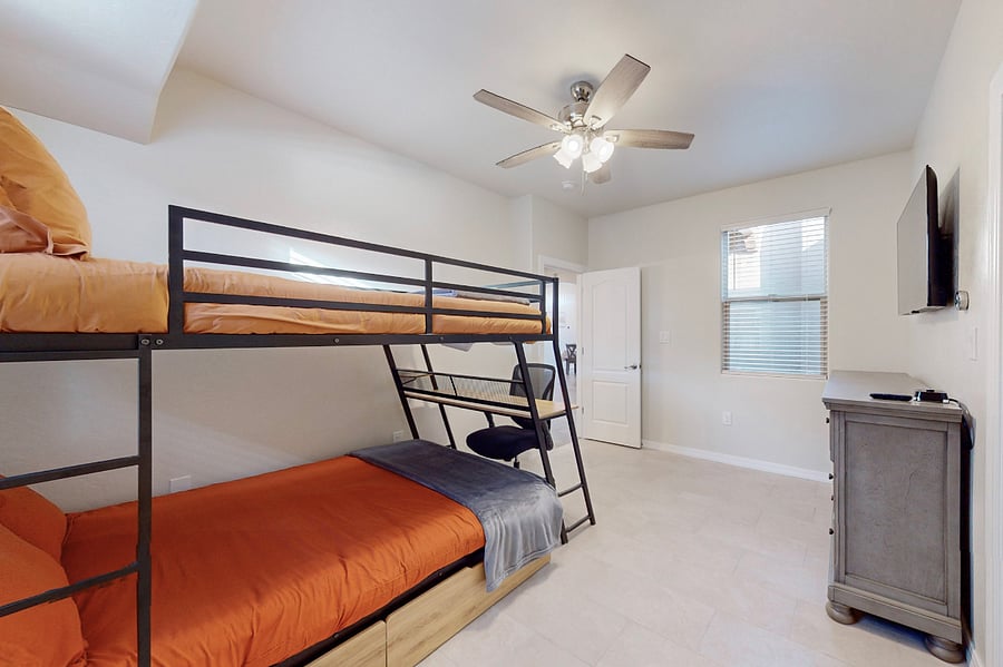 Stay & play in this versatile room featuring dual full size bunk beds with a workspace, ample storage, and a Roku Smart TV with the full main bathroom adjacent- perfect for kids or teens during your extended family stay.