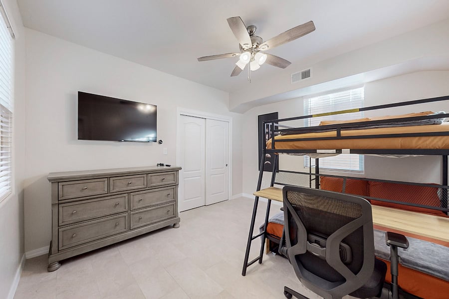 Stay & play in this versatile room featuring dual full size bunk beds with a workspace, ample storage, and a Roku Smart TV with the full main bathroom adjacent- perfect for kids or teens during your extended family stay.