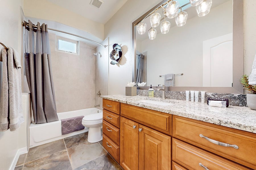 The main full bathroom features a bathtub and shower, serving as a shared community bathroom for guests and providing convenient access for those staying in the adjacent bedroom three.
