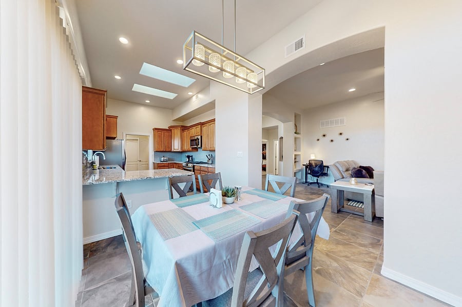 Gather around this spacious dining table, perfect for enjoying family meals, game nights, and sharing memories together during your stay. The open floor plan means you can all be together whether you are in the living room, dining room, or kitchen.