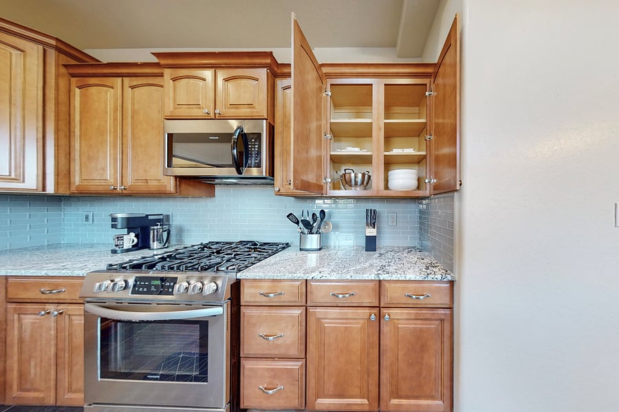 This modern kitchen is fully stocked with both small and large appliances, providing everything you need to prepare breakfast, lunch, dinner, dessert, and all the snacks you desire.