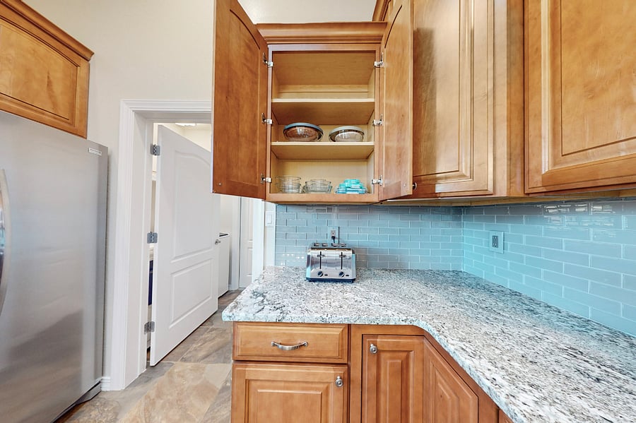 This modern kitchen is fully stocked with both small and large appliances, providing everything you need to prepare breakfast, lunch, dinner, dessert, and all the snacks you desire.
