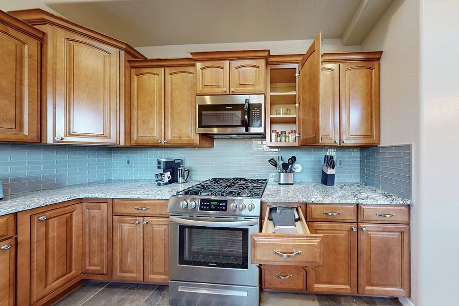 This modern kitchen is fully stocked with both small and large appliances, providing everything you need to prepare breakfast, lunch, dinner, dessert, and all the snacks you desire.