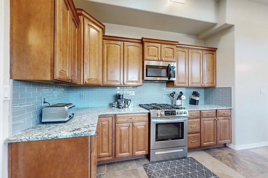 This modern kitchen is fully stocked with both small and large appliances, providing everything you need to prepare breakfast, lunch, dinner, dessert, and all the snacks you desire.