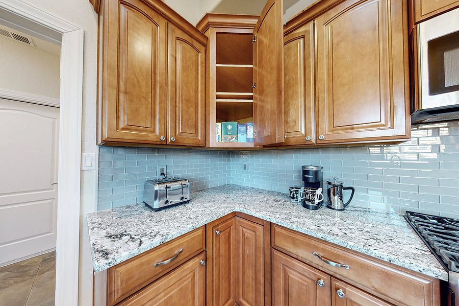 This modern kitchen is fully stocked with both small and large appliances, providing everything you need to prepare breakfast, lunch, dinner, dessert, and all the snacks you desire.
