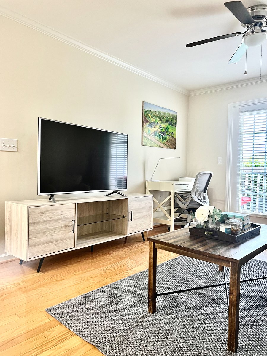 Living area includes a desk space with office supplies, a printer and ink. Back door leads to private patio area. 