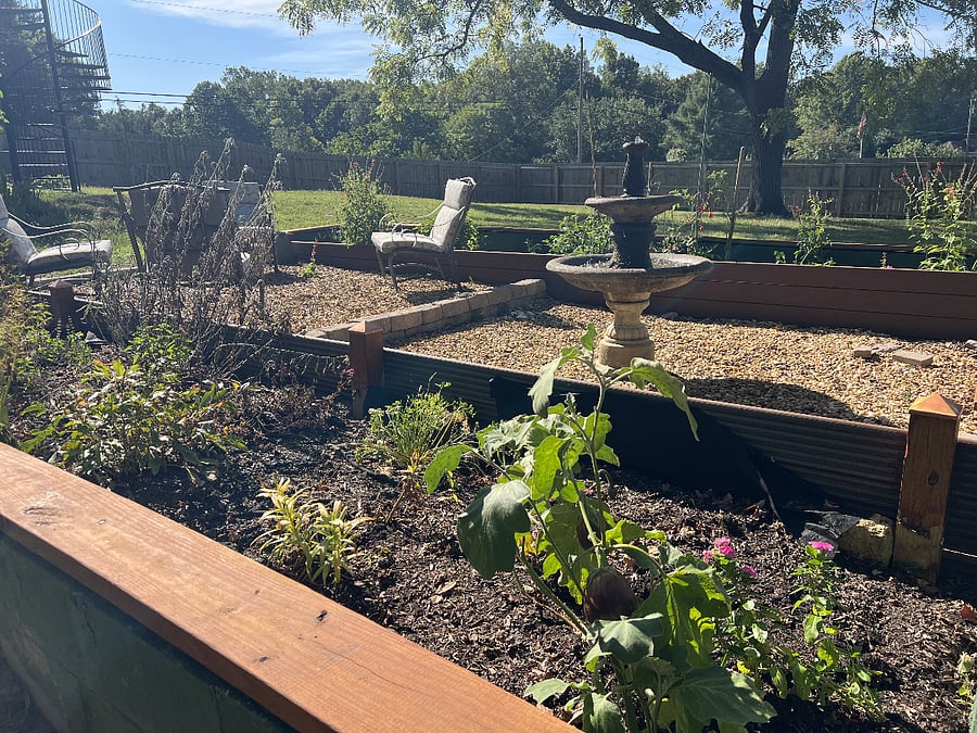 Enjoy the zen of our raised-garden-bed patio and fountain in the backyard.