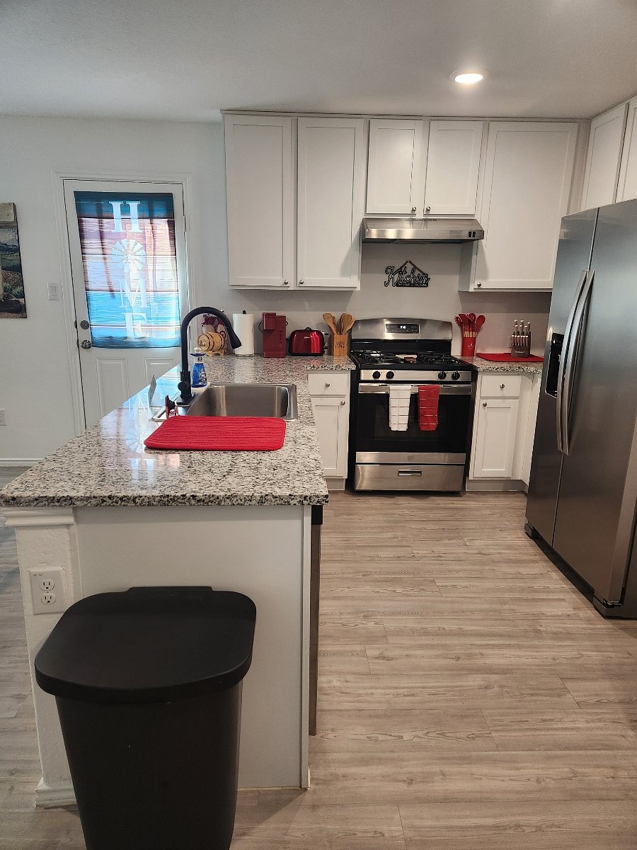 Kitchen with toaster, blender, utensils, Keurig coffee maker, and much more for cooking and baking.