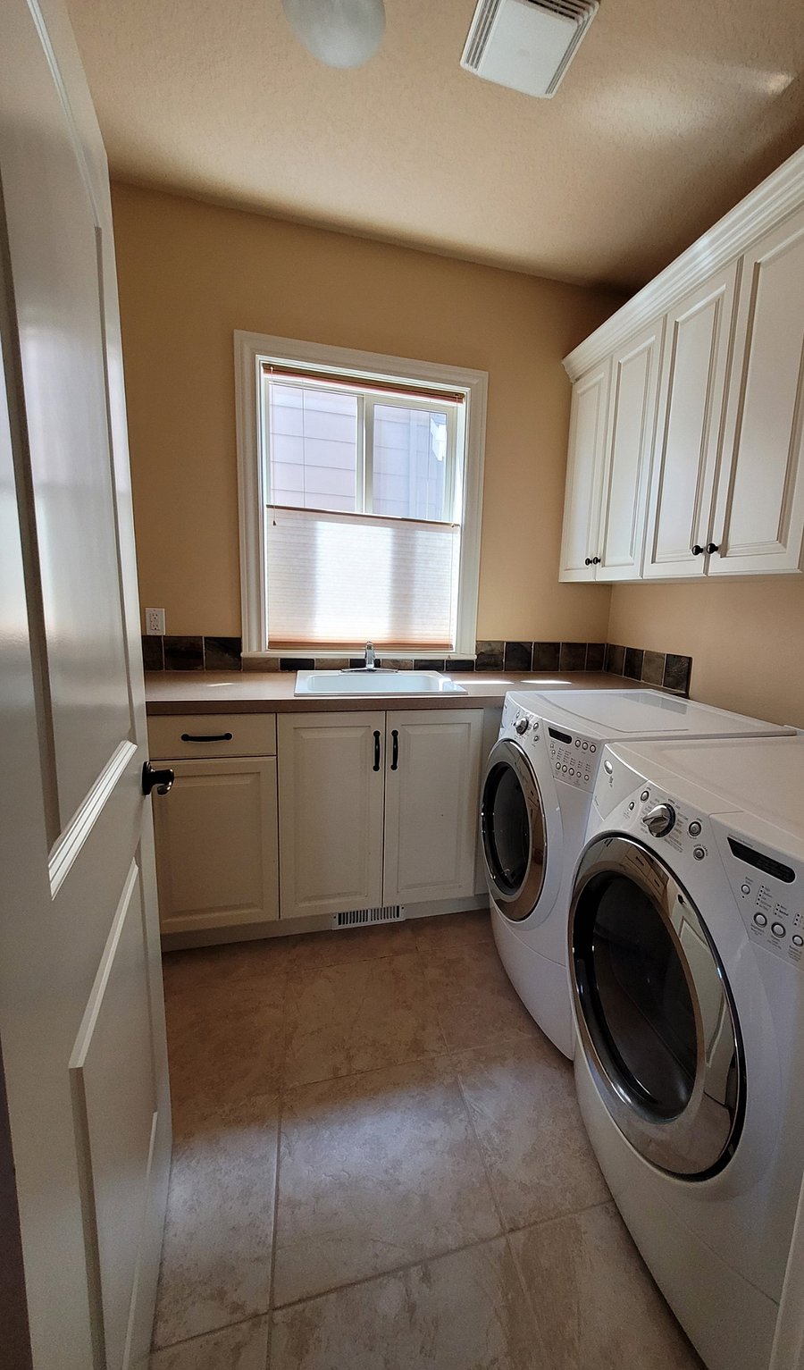 Utility room on main level. Washer/Dryer and deep wash basin (common area).