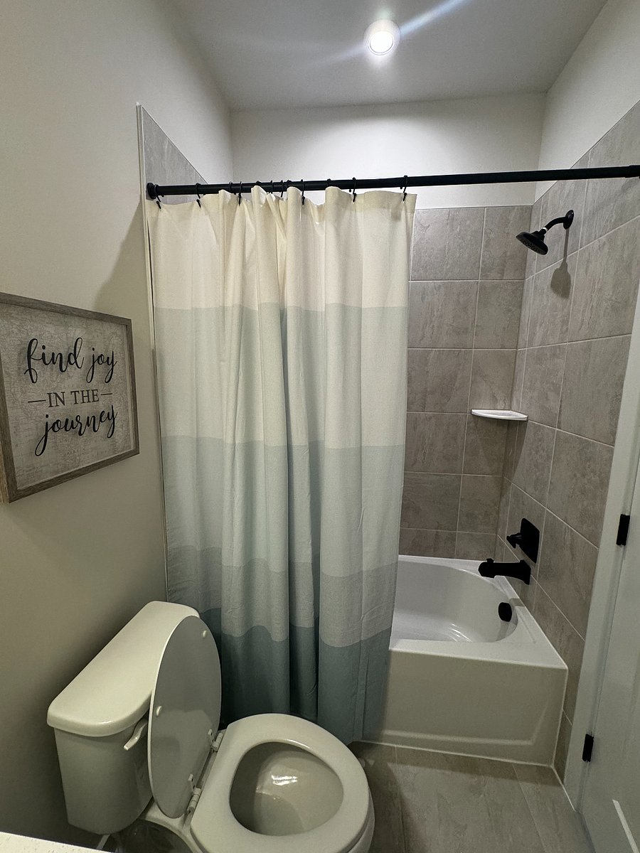 Full bathroom with shower and tub.