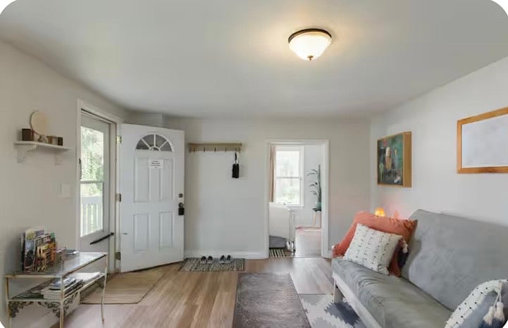 Small porch with table and two chairs outside of this entrance to living room.