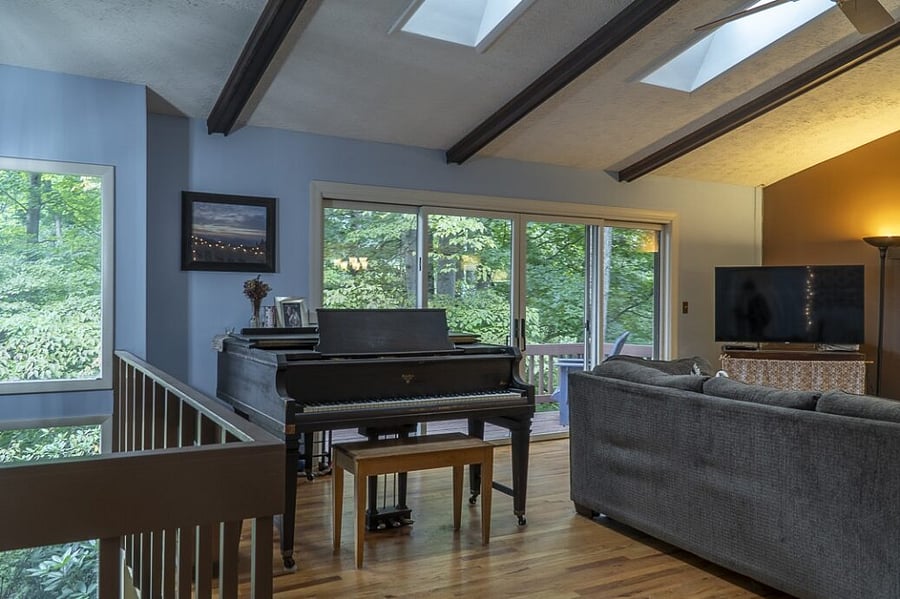 Play the baby grand piano overlooking your private forest