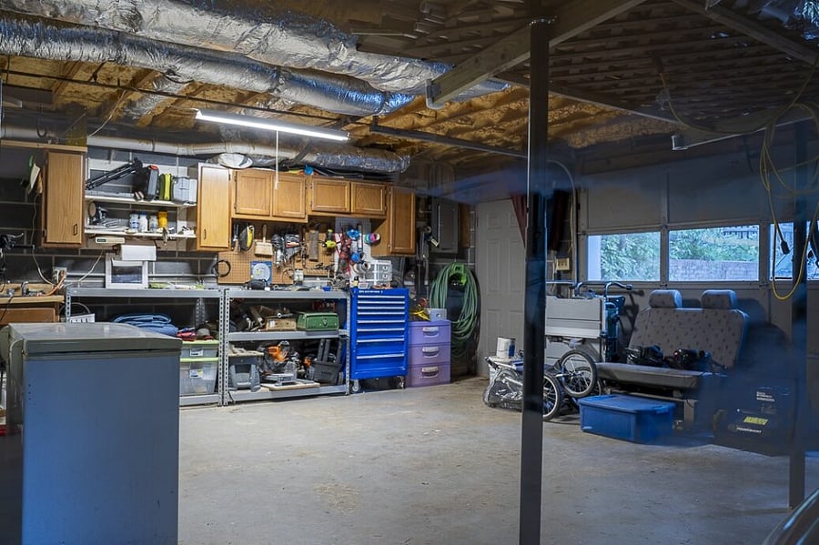 Garage has lots of room for storage plus a chest freezer.