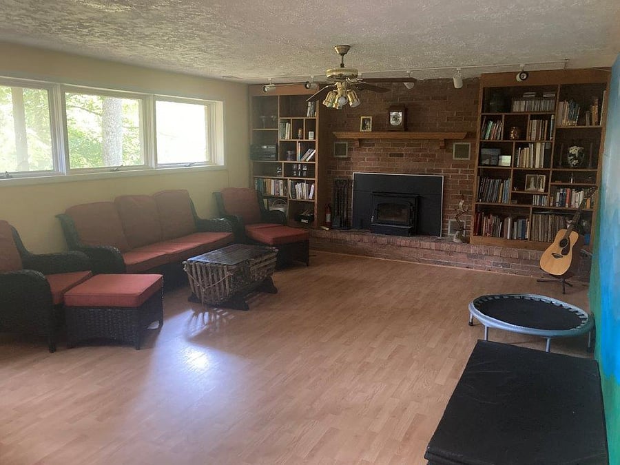 Family room with wood burning fireplace and library