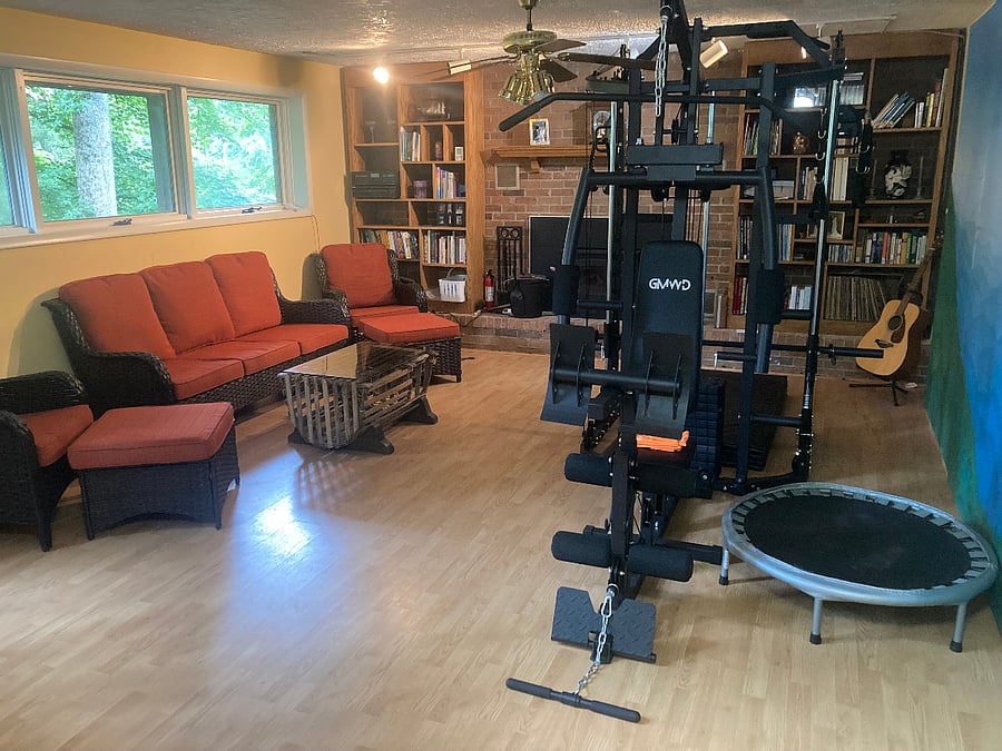 Family room with home gym, wood burning fireplace and library