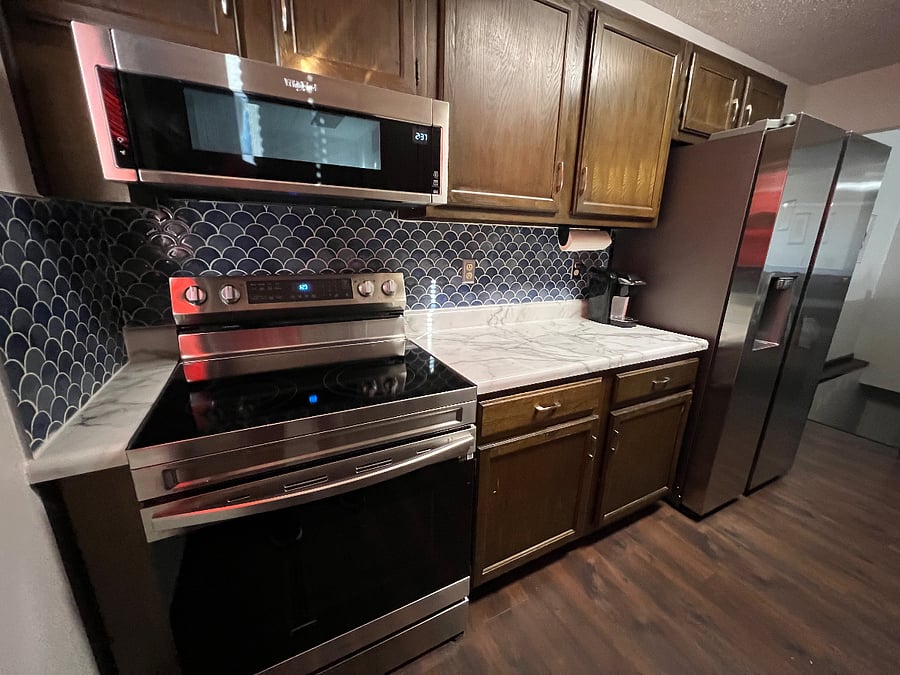 Right side of Kitchen - Brand new range, microwave and fridge