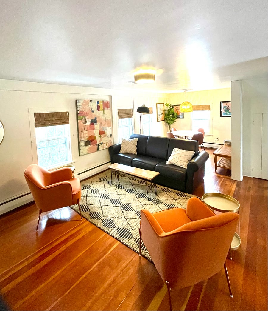 Open floor plan - living area with sleeper couch and dining area.