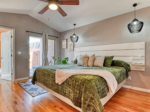 Owner retreat with King Bed and sliding door leading to backyard