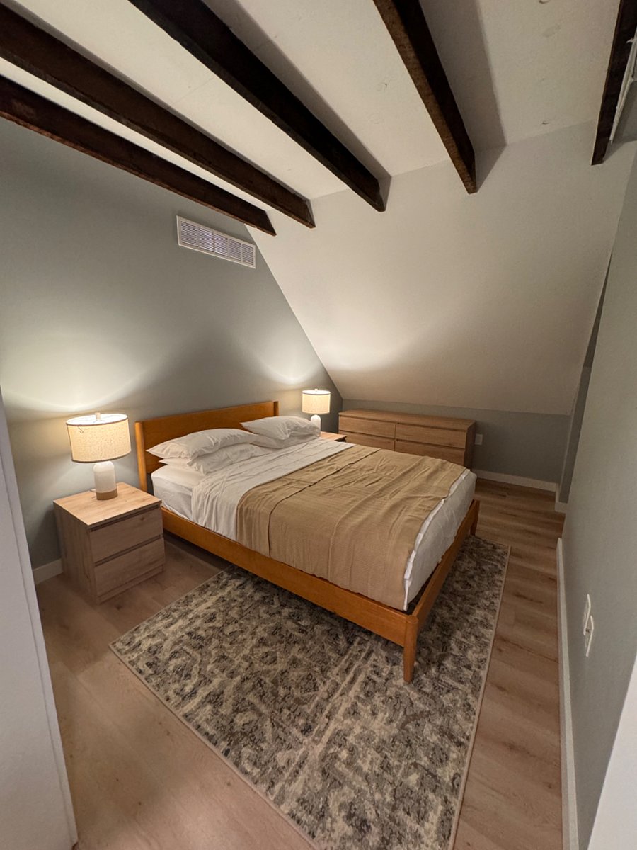 Queen sized bedroom separate from living room and kitchen.