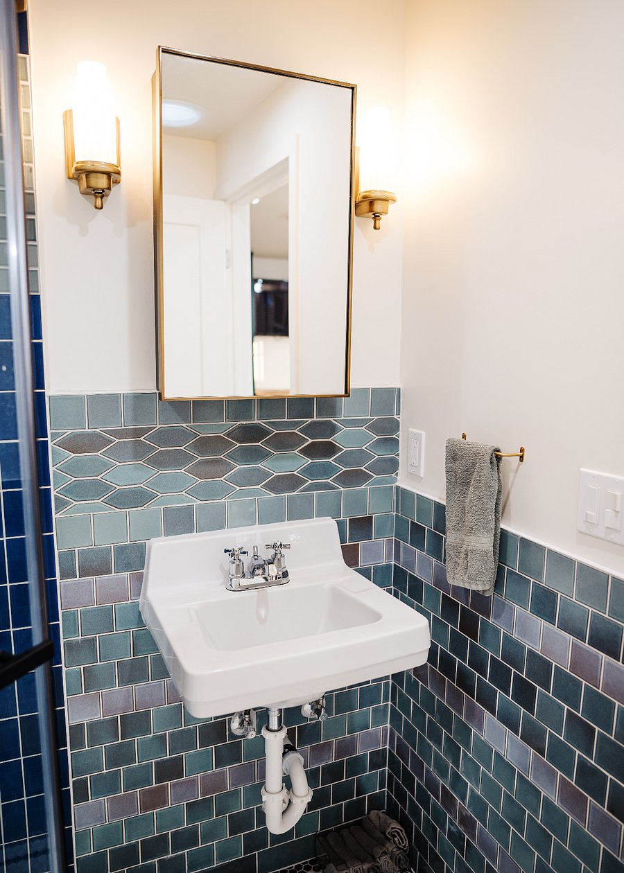 Custom Heath tile in bathroom, vintage sink and lighting fixtures