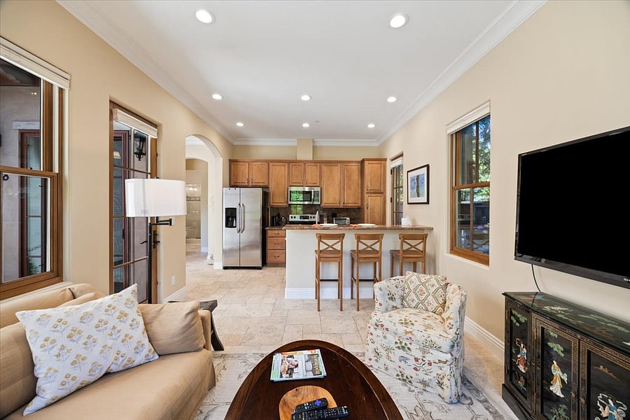 living room looking out to breakfast bar and kitchen