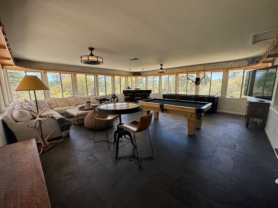 Game room with spectacular views! Pool table, shuffleboard board, darts, bar and large smart tv. Huge comfy sectional with lots of seating.
