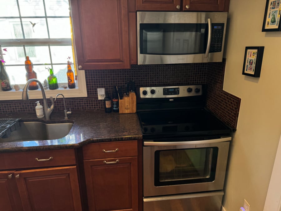 Microwave, oven, fridge, large sink with retractable faucet, and an in-sink water filtration system.