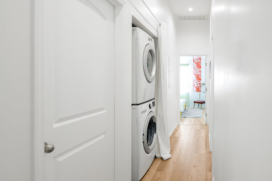 Hallway with laundry nook, washer and dryer.