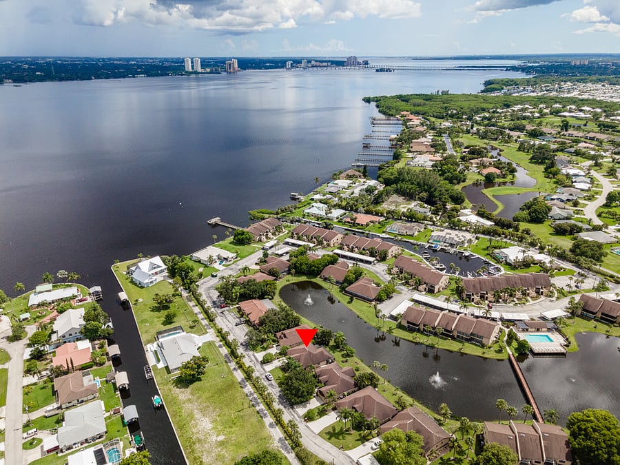 View of Admiralty Yacht Club and Caloosahatchee River. Red indicator shows House location.