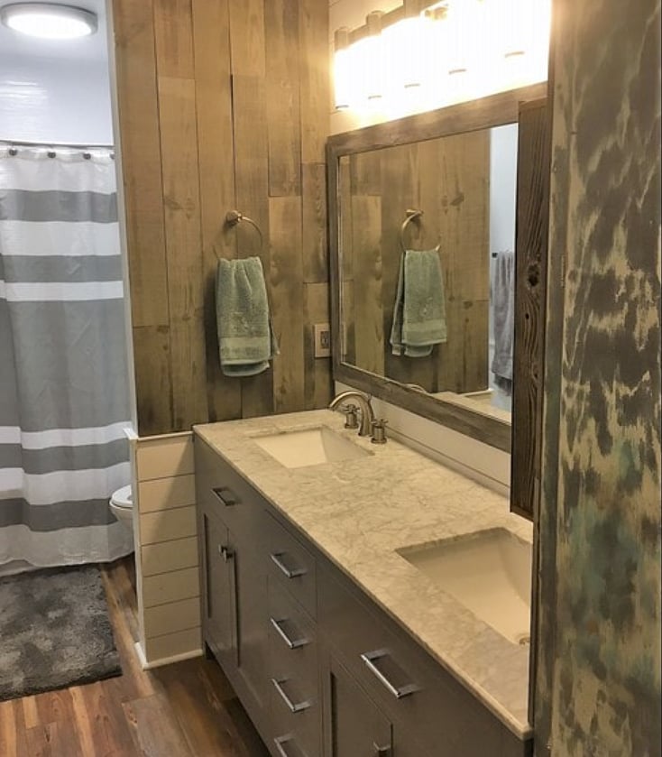 Full bathroom with tub connected to king sized bedroom