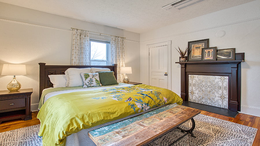 Bedroom 2 with king bed and retired fireplace.