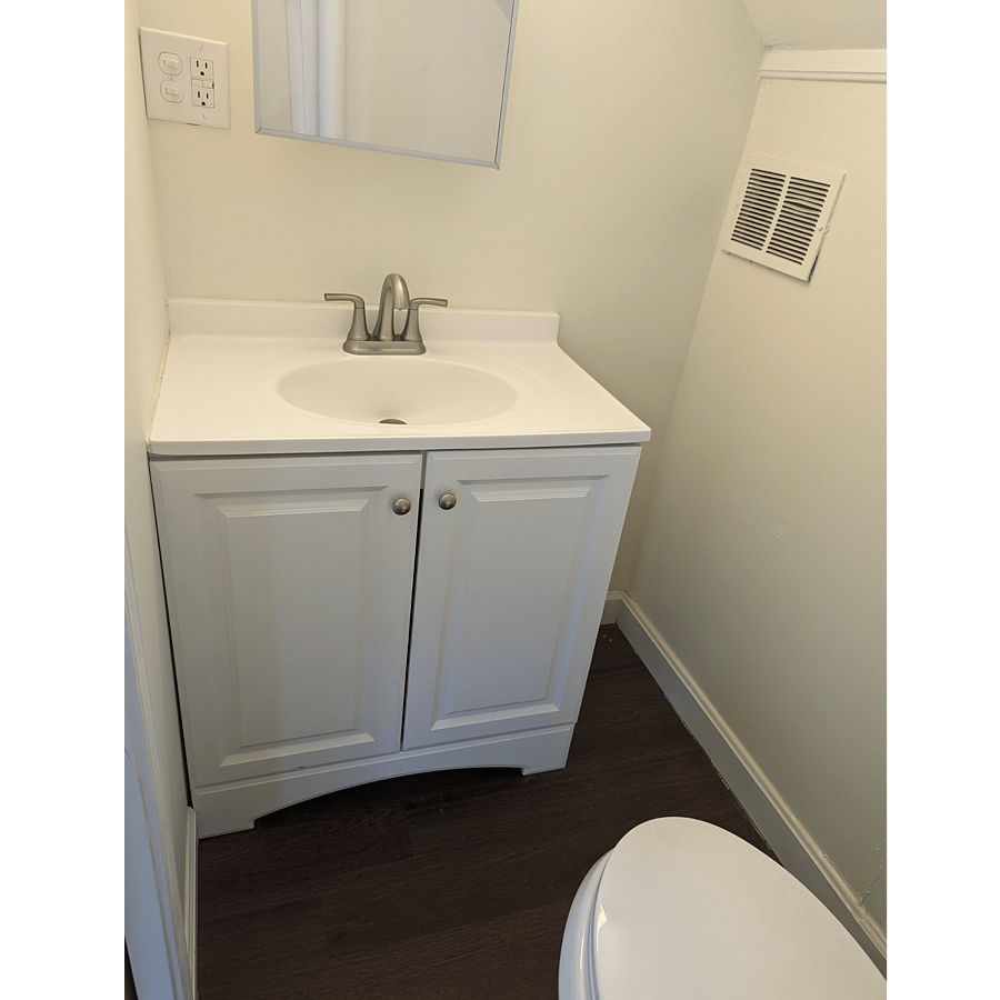 En suite half bath to upstairs bedroom with daybed.