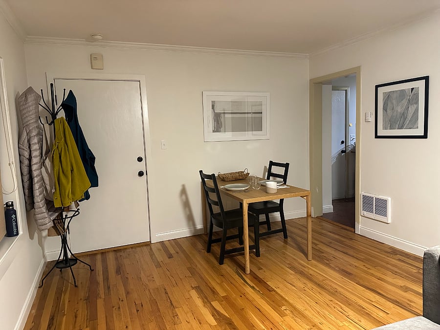 Entry with coat rack and dining area