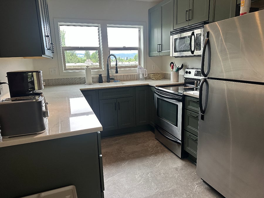 Kitchen updated in 2025 with quartz counters, flooring, dishwasher and microwave.