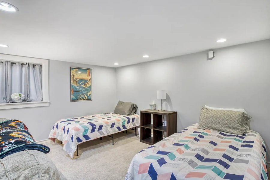 Basement Studio Bedroom 2 sofas, flat screen tv, and 4 twin beds