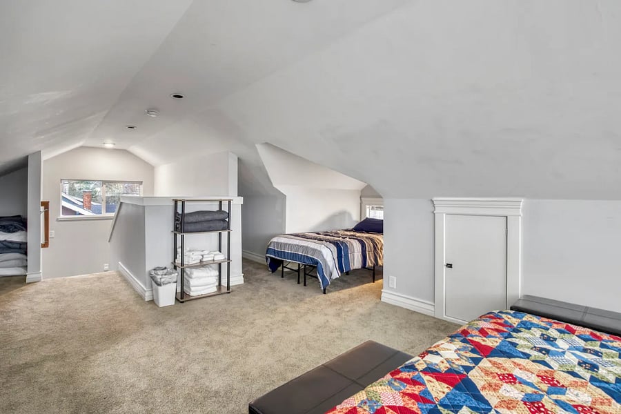 Attic entrance, also pictured Queen size bed and attic Twin Bed