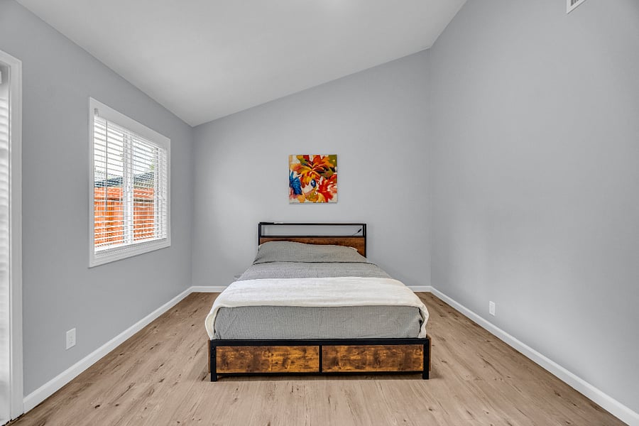 Cozy and well-lit room featuring a stylish platform bed, promising a restful stay.