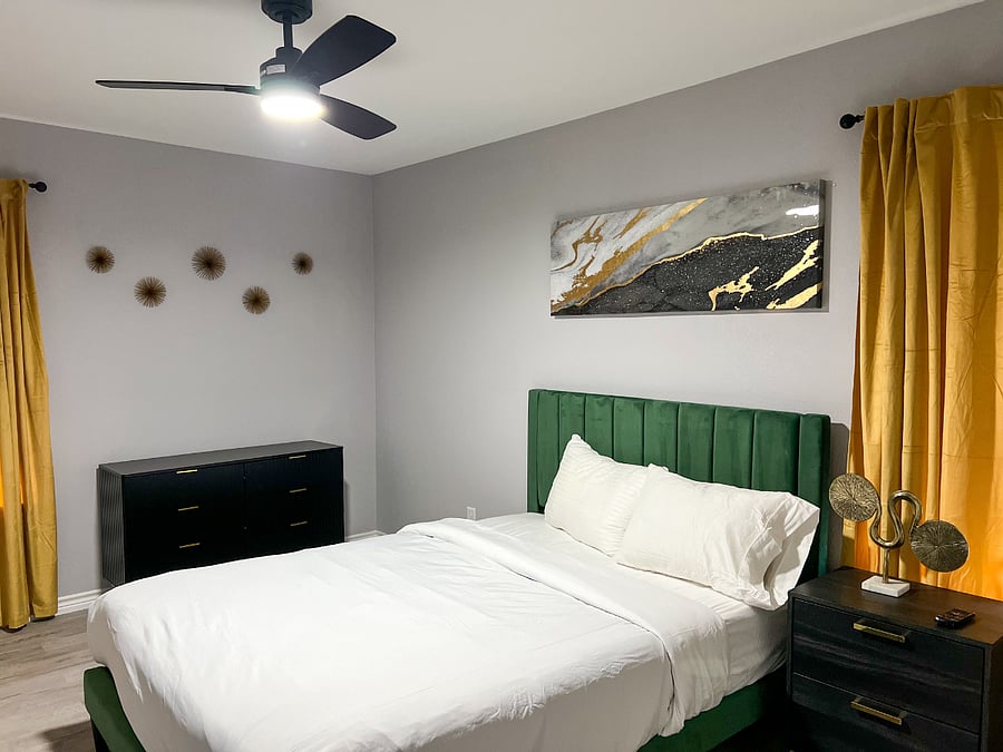 Spacious queen bedroom with direct access to a private en-suite bathroom featuring a luxury walk-in showerdesigned for comfort, privacy, and relaxation.