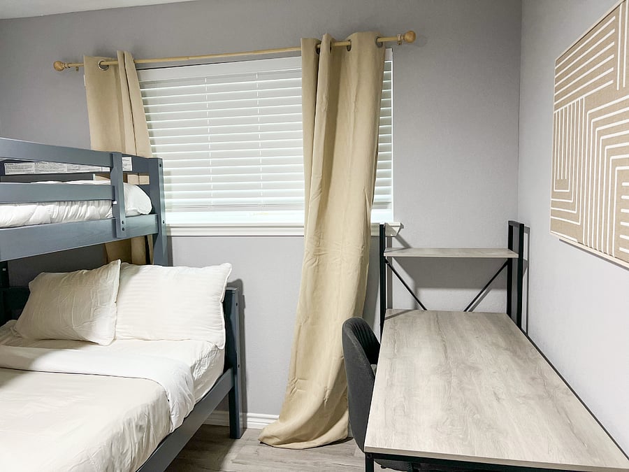 Cozy bunk bed setup with a full-size bottom bunk and a twin-size topperfect for families, travel nurses, or roommates needing flexible sleeping arrangements.