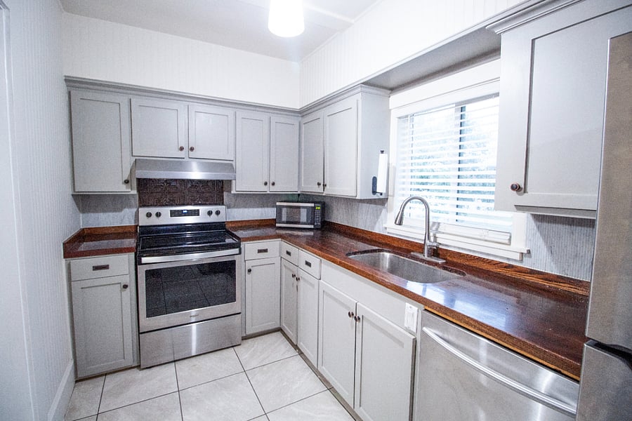 Kitchen with full sized refrigerator, electric stove, dishwasher, and garbage disposal. Tons of storage.