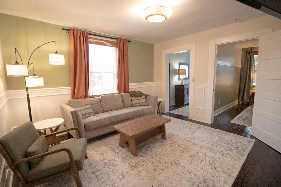 Living room leading to entryway and bedroom