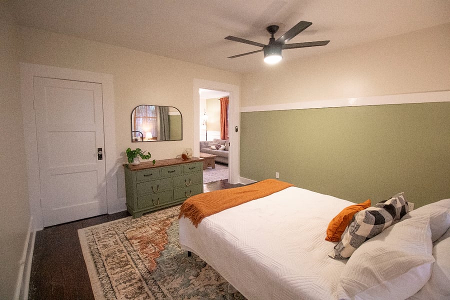 Bedroom with dresser and closet leading to the living room