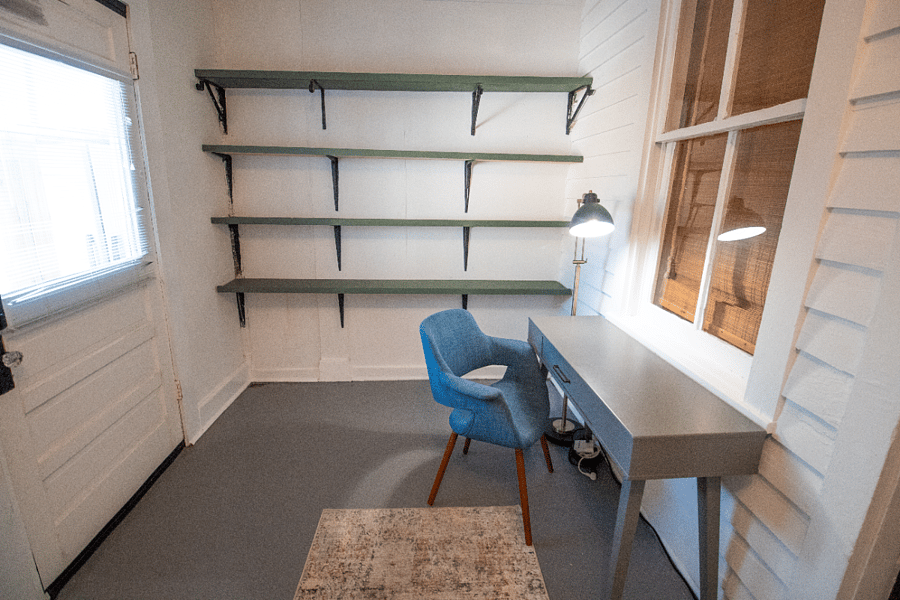 A beautifully styled study nook featuring a sleek desk with built-in shelves. Natural light pours in, creating a calm and focused atmosphere perfect for studying or creative work.