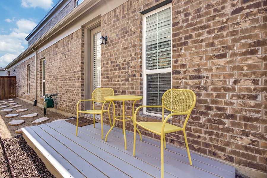 Outdoor patio deck located on the left side of the house with table and 2 chairs. Private guest side entrance with keypad code door lock for keyless entry.