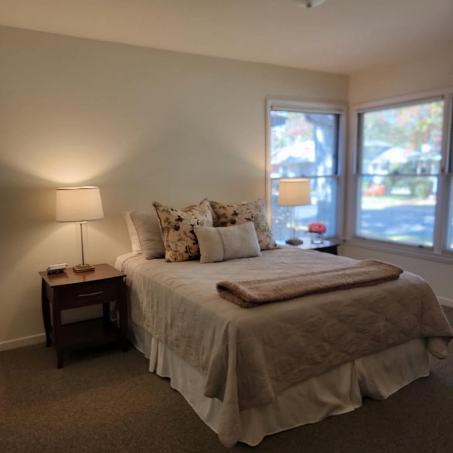 Larger of the two bedrooms. Corner windows. Carpeted floor.