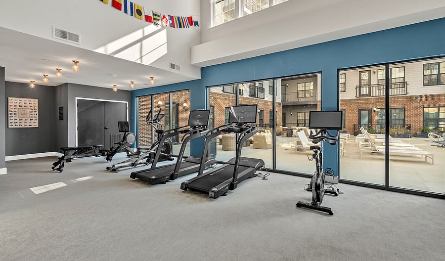 Gym with view of the pool and courtyard
