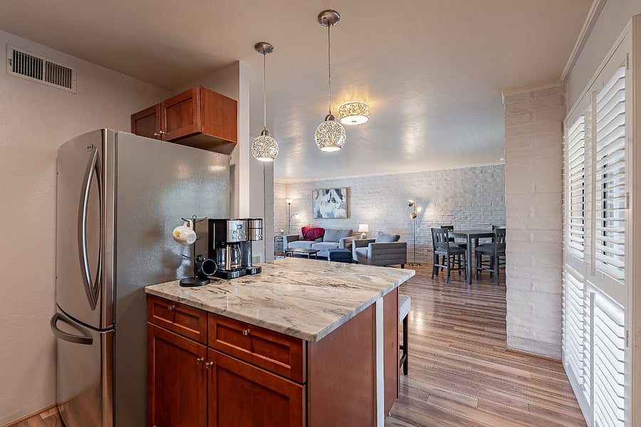 View of living area from kitchen. Full size refrigerator.