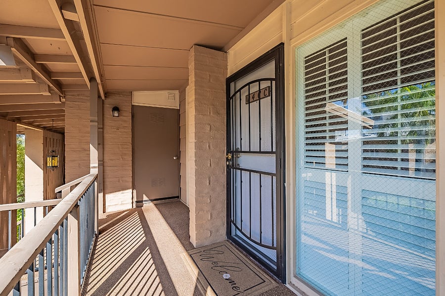 Entrance to unit with keyless entry and security gate. Entrance to exclusive laundry room is in the background.