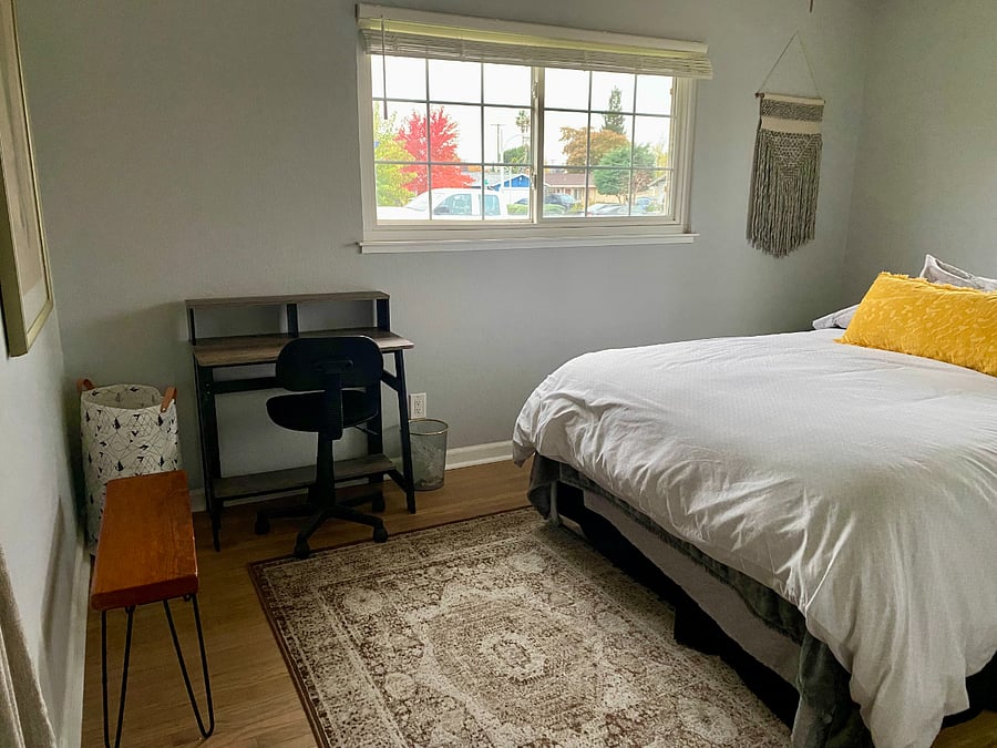 Tenant room: queen sized bed, desk, chair, trash can, blanket basket. There is a ceiling fan and the blinds work great to block out the light.